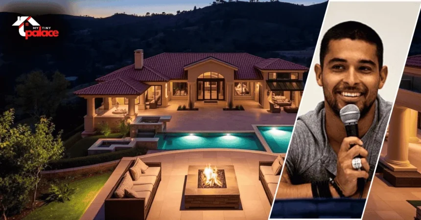 Image showing the Wilmer Valderrama house with the Spanish-style villa in the background and a framed portrait of Wilmer Valderrama displayed at the front.