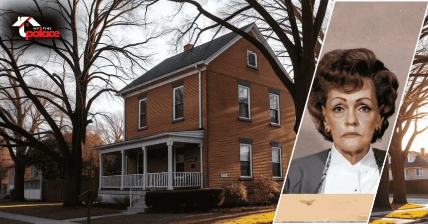 Image showing the house gertrude baniszewski with the modest home in the background and a framed portrait of the former owner placed at the front.