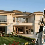 The ethan kleins house shown from the outside with the home in the background and a framed portrait of Ethan Klein placed at the front.