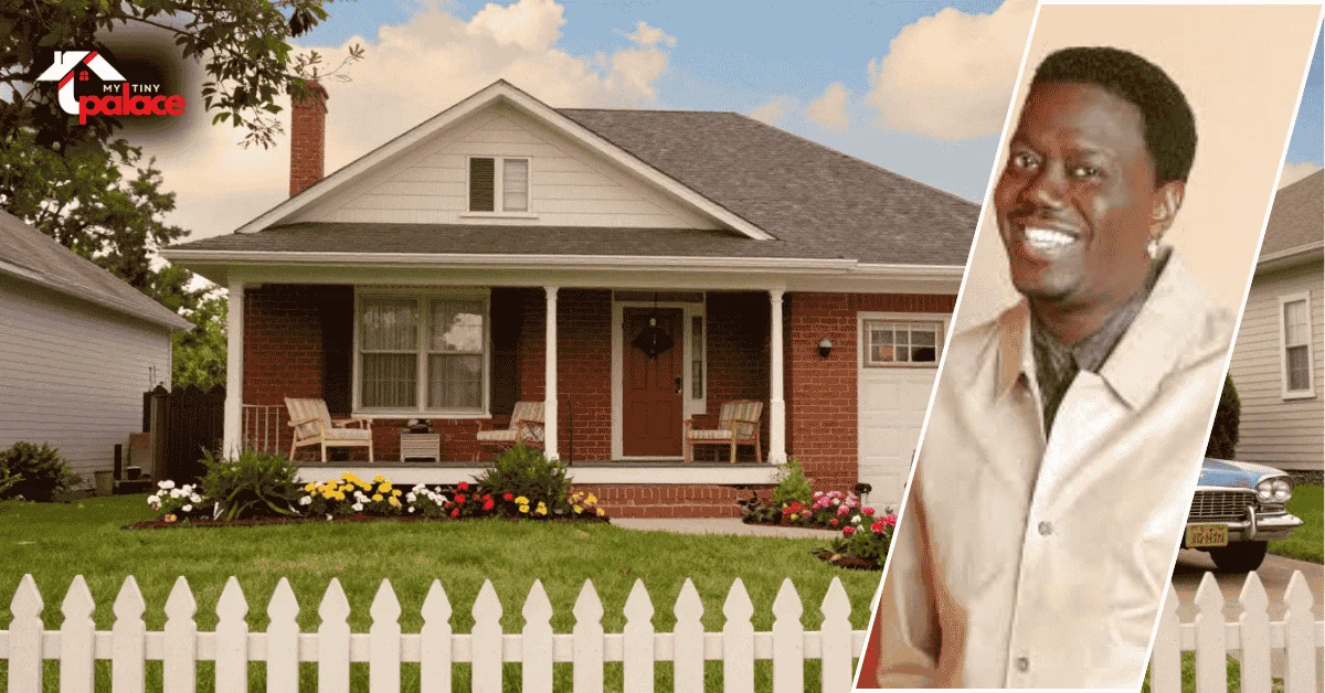 Image of the the bernie mac show house showing the exterior of the home in the background with a framed portrait of Bernie Mac placed at the front