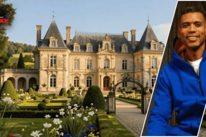 A wide shot of the allan houston house showcasing its limestone French Manor design and manicured lawn with a framed portrait of Allan Houston positioned in the foreground.
