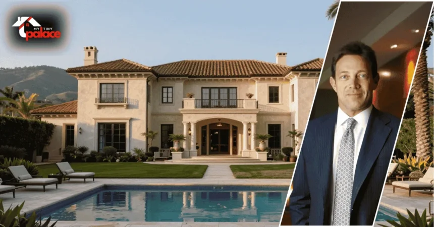 An exterior photograph of the jordan belfort house featuring the large shingle-style architecture and green landscape in the background with a framed portrait of Jordan Belfort in the foreground.