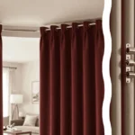A pair of sturdy tension rods for heavy curtains installed in a large window frame with a renovated living room in the background and a close-up of the non-slip rubber end cap in the foreground.