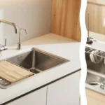 An overhead view of a workstation sink organization setup showing a finished kitchen renovation with a close-up of a brushed metal colander and integrated walnut drying rack in the foreground.